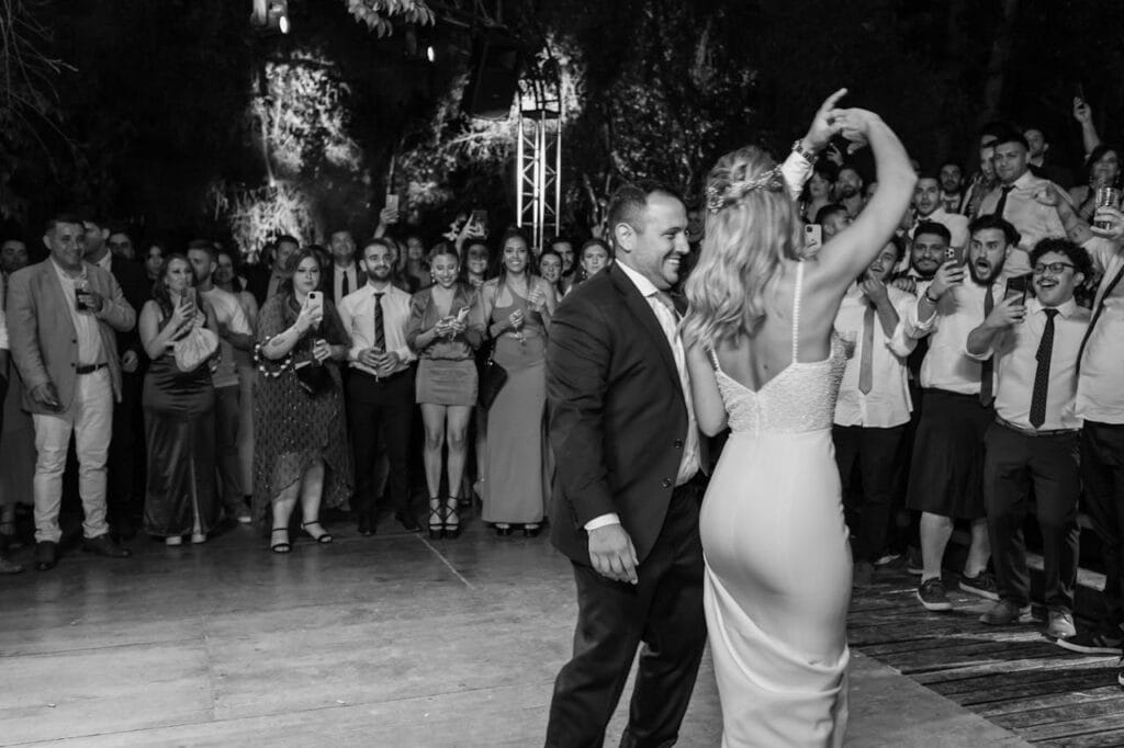 Elegant black and white photo capturing a lively wedding dance party in Mendoza, Argentina.