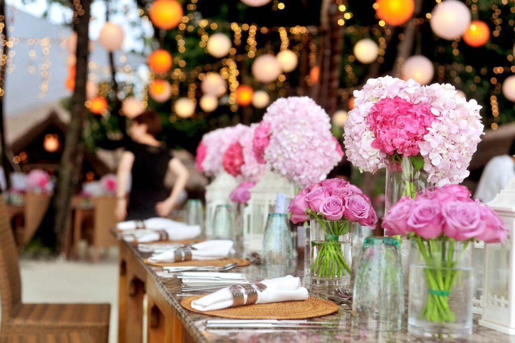 pexels-photo-169190-169190 Elegant outdoor wedding setup featuring pink floral arrangements and soft lighting.